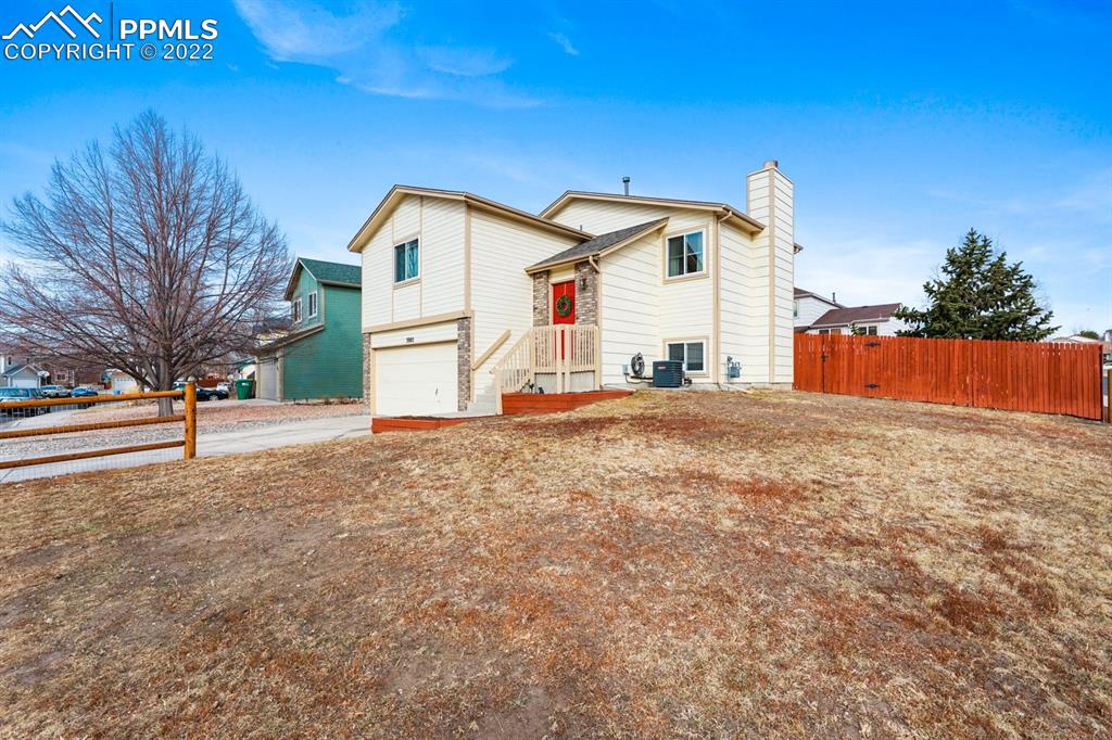 5805 Dutchess Drive Colorado Springs, CO 80923 - Photo 30 of 34 a front view of a house with a yard