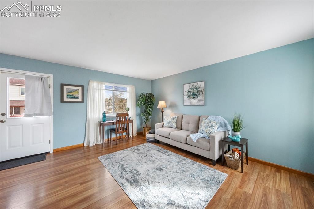5805 Dutchess Drive Colorado Springs, CO 80923 - Photo 3 of 34 a living room with furniture and wooden floor