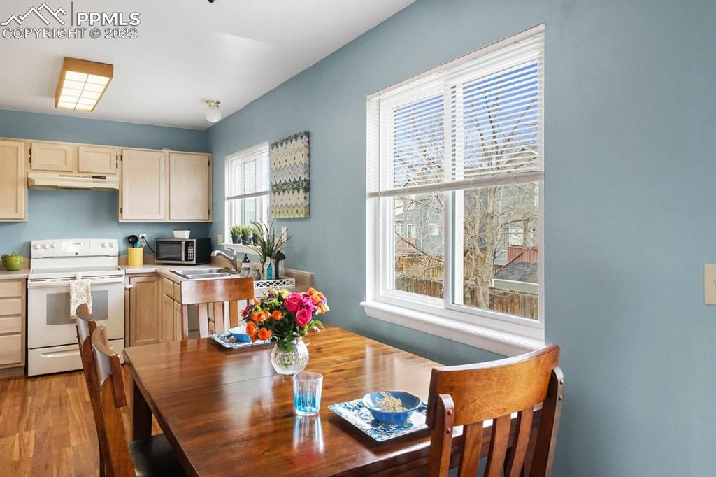 5805 Dutchess Drive Colorado Springs, CO 80923 - Photo 8 of 34 a living room with dining room and wooden floor