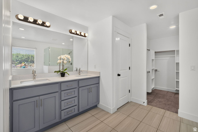 6536 West Muirfield Road Highland, UT 84003 - Photo 29 of 48 Dual vanity with light gray cabinetry, integrated sinks, and polished chrome fixtures