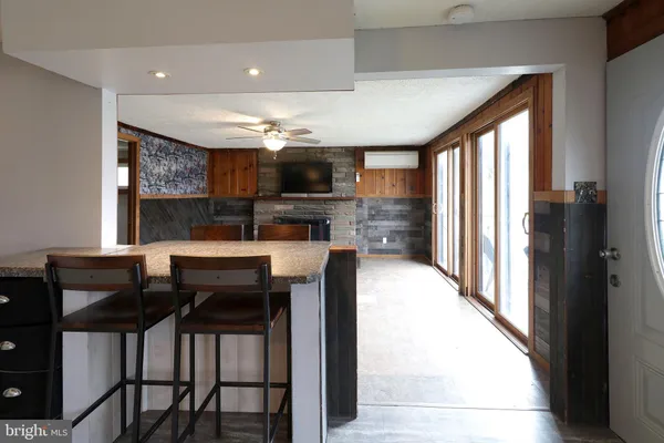 a view of an empty room with a fireplace and a window