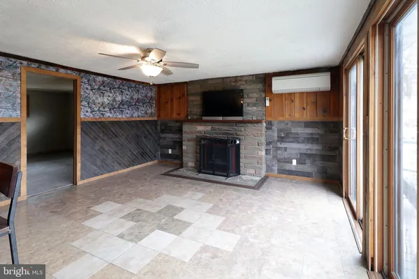 a living room with fireplace and a rug