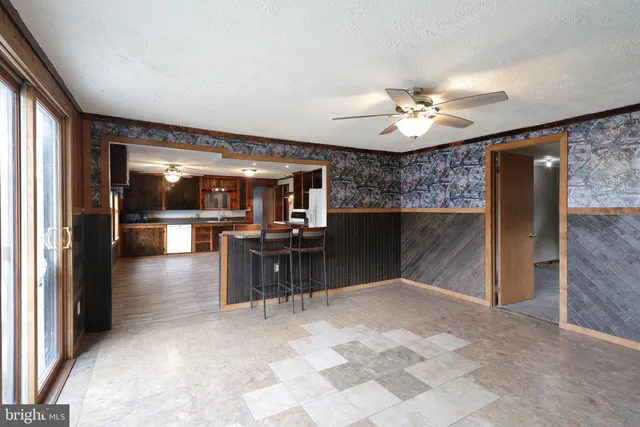 an empty room with closet and windows