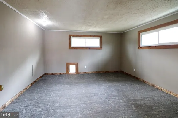 a bathroom with a granite countertop toilet sink and mirror
