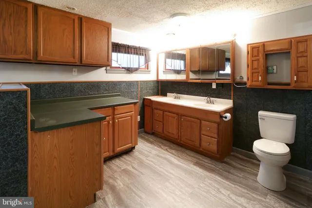 a bathroom with a toilet a sink and shower