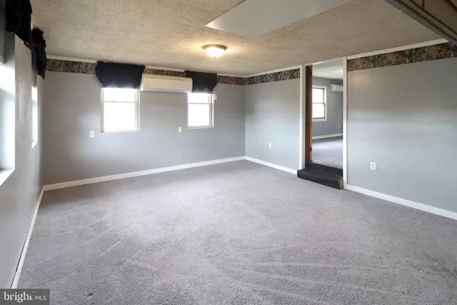 a view of empty room with wooden ceiling
