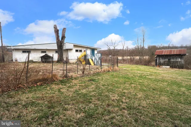 a view of outdoor space with deck and yard