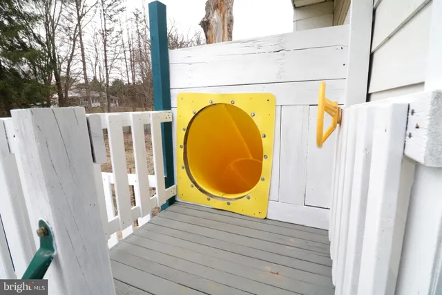 a view of a house with a yard and deck