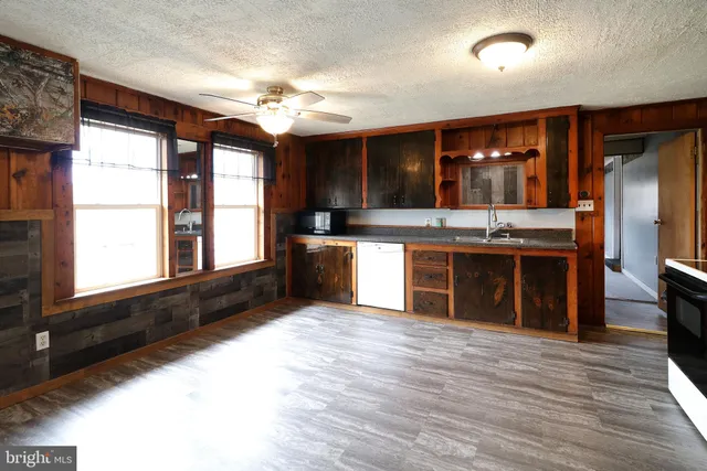 a large kitchen with stainless steel appliances granite countertop a stove and a sink