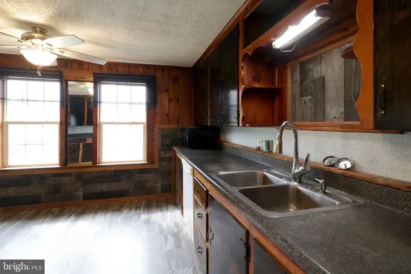 a kitchen with stainless steel appliances granite countertop a refrigerator and a stove