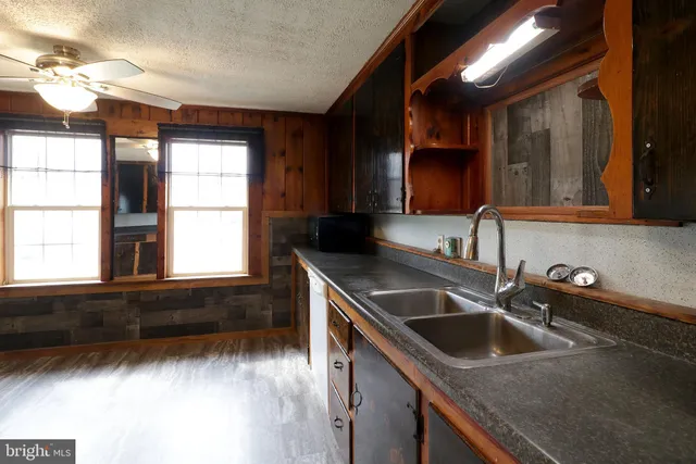 a kitchen with stainless steel appliances granite countertop a refrigerator and a stove
