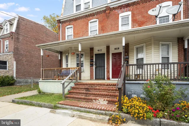front view of a brick house with a small yard