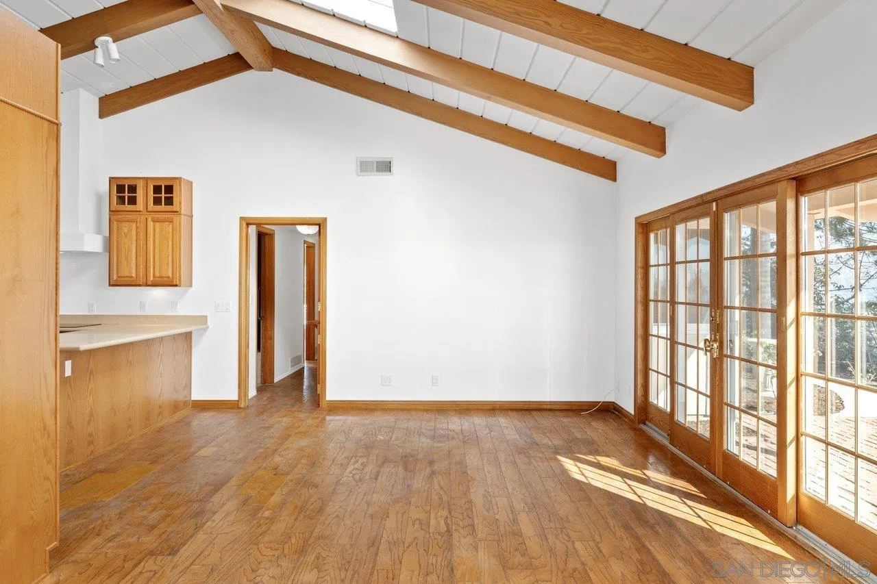 2169 Rockhoff Road Escondido, CA 92026 - Photo 12 of 22 a view of an empty room with wooden floor and a window
