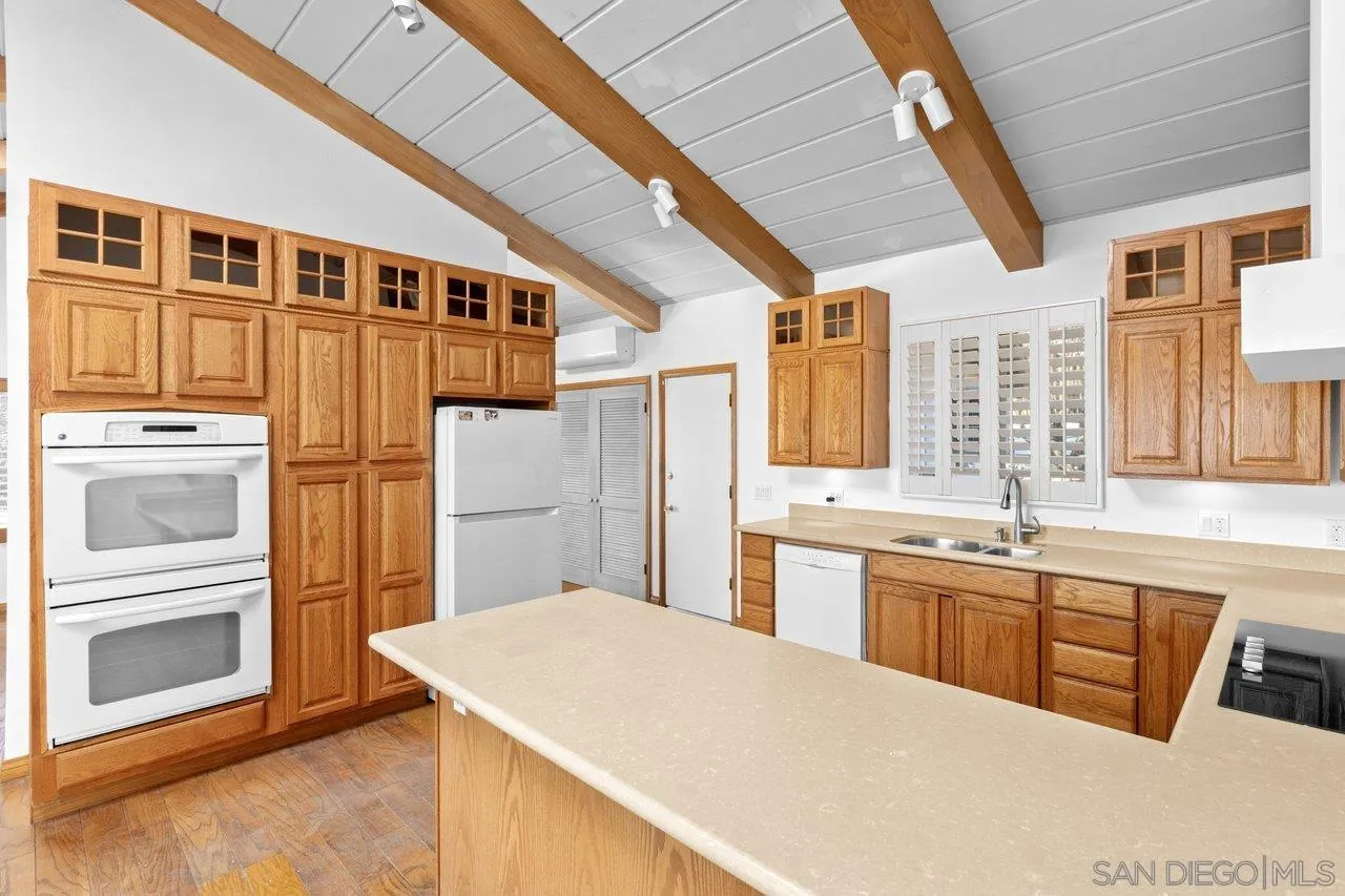 2169 Rockhoff Road Escondido, CA 92026 - Photo 15 of 22 a kitchen with stainless steel appliances granite countertop a refrigerator and a stove top oven
