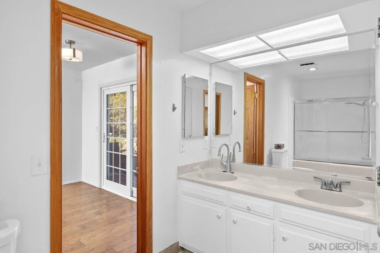 2169 Rockhoff Road Escondido, CA 92026 - Photo 17 of 22 a bathroom with a sink and a mirror
