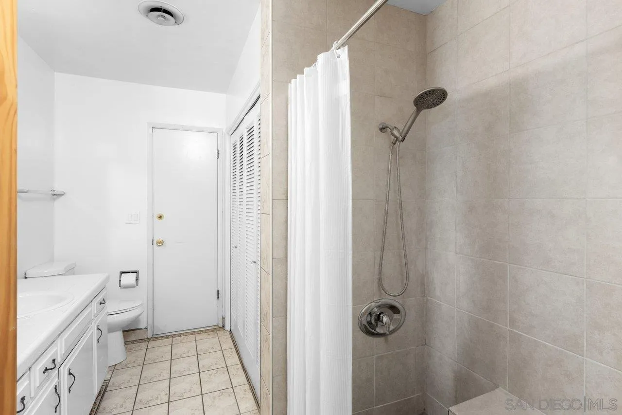 2169 Rockhoff Road Escondido, CA 92026 - Photo 20 of 22 a bathroom with a granite countertop shower a sink and a toilet
