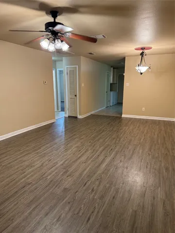 a view of an empty room and wooden floor