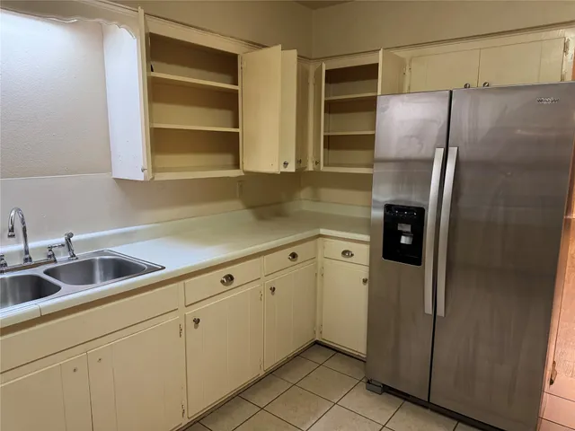 a kitchen with stainless steel appliances cabinets and a refrigerator