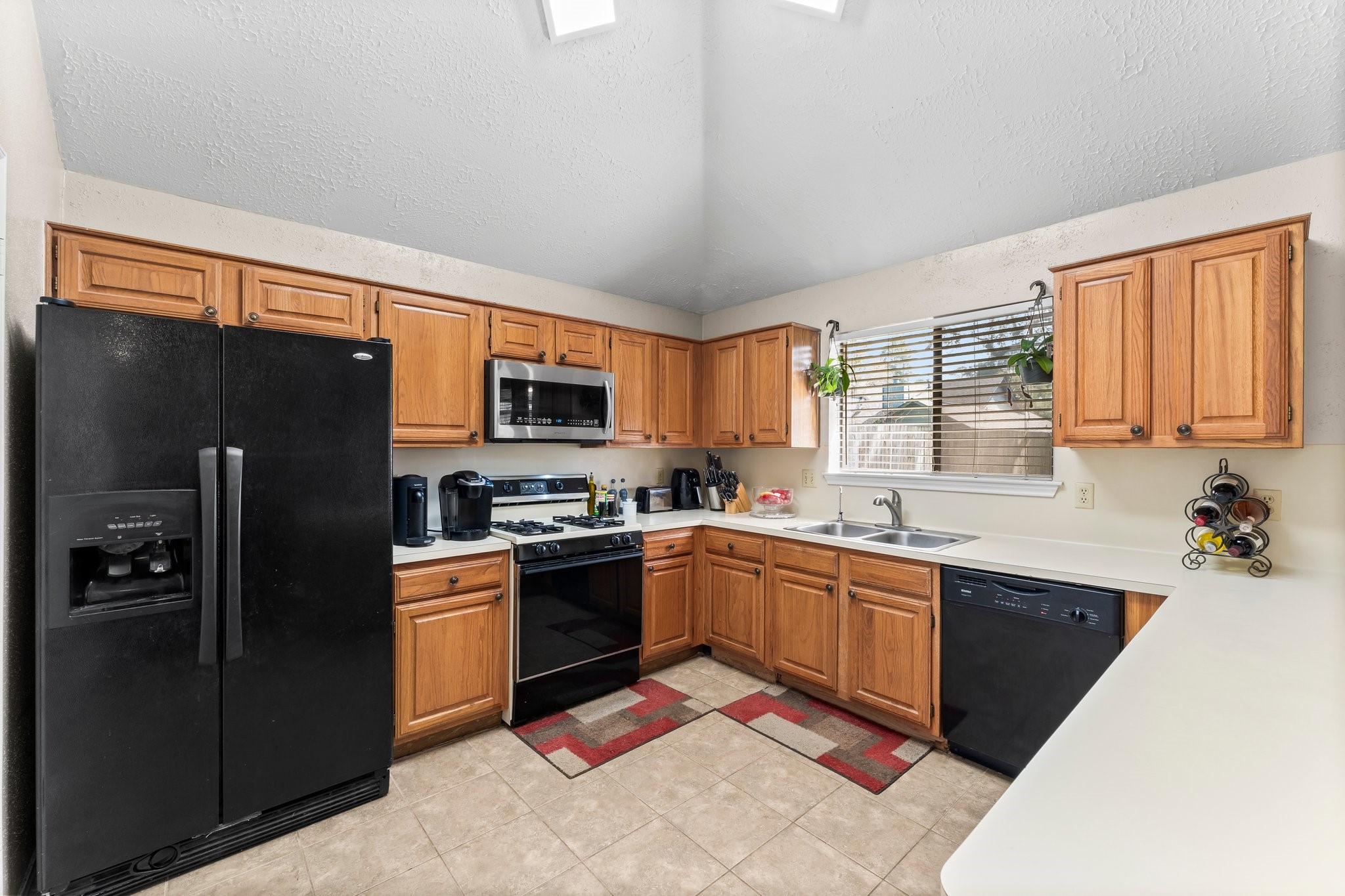 2110 Creston Drive Spring, TX 77386 - Photo 16 of 50 a kitchen with stainless steel appliances granite countertop a refrigerator a sink dishwasher a stove top oven a refrigerator with island and chairs