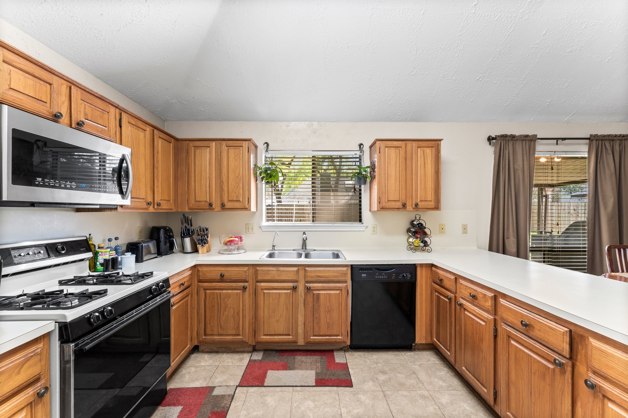2110 Creston Drive Spring, TX 77386 - Photo 17 of 50 a kitchen with a sink stove and microwave