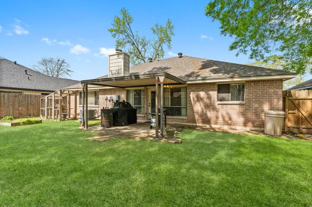 a view of a house with a yard and sitting area