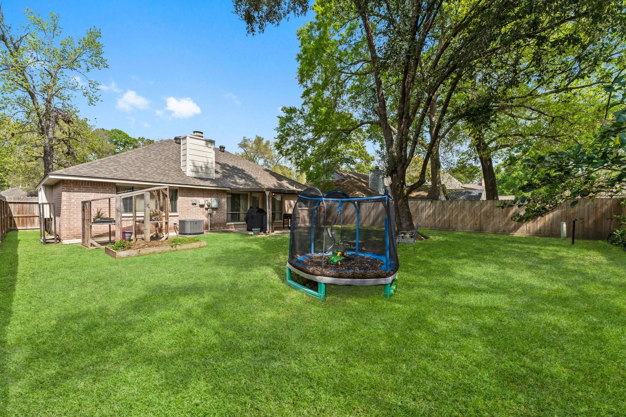 2110 Creston Drive Spring, TX 77386 - Photo 35 of 50 a front view of a house with a garden