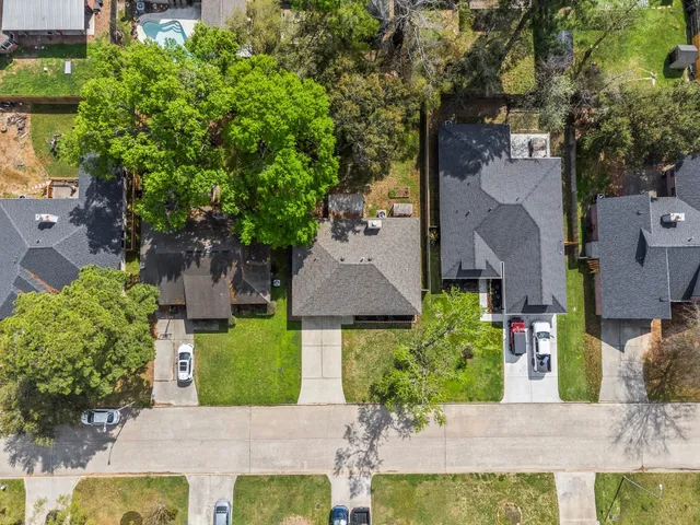 an aerial view of a house with a yard and fountain