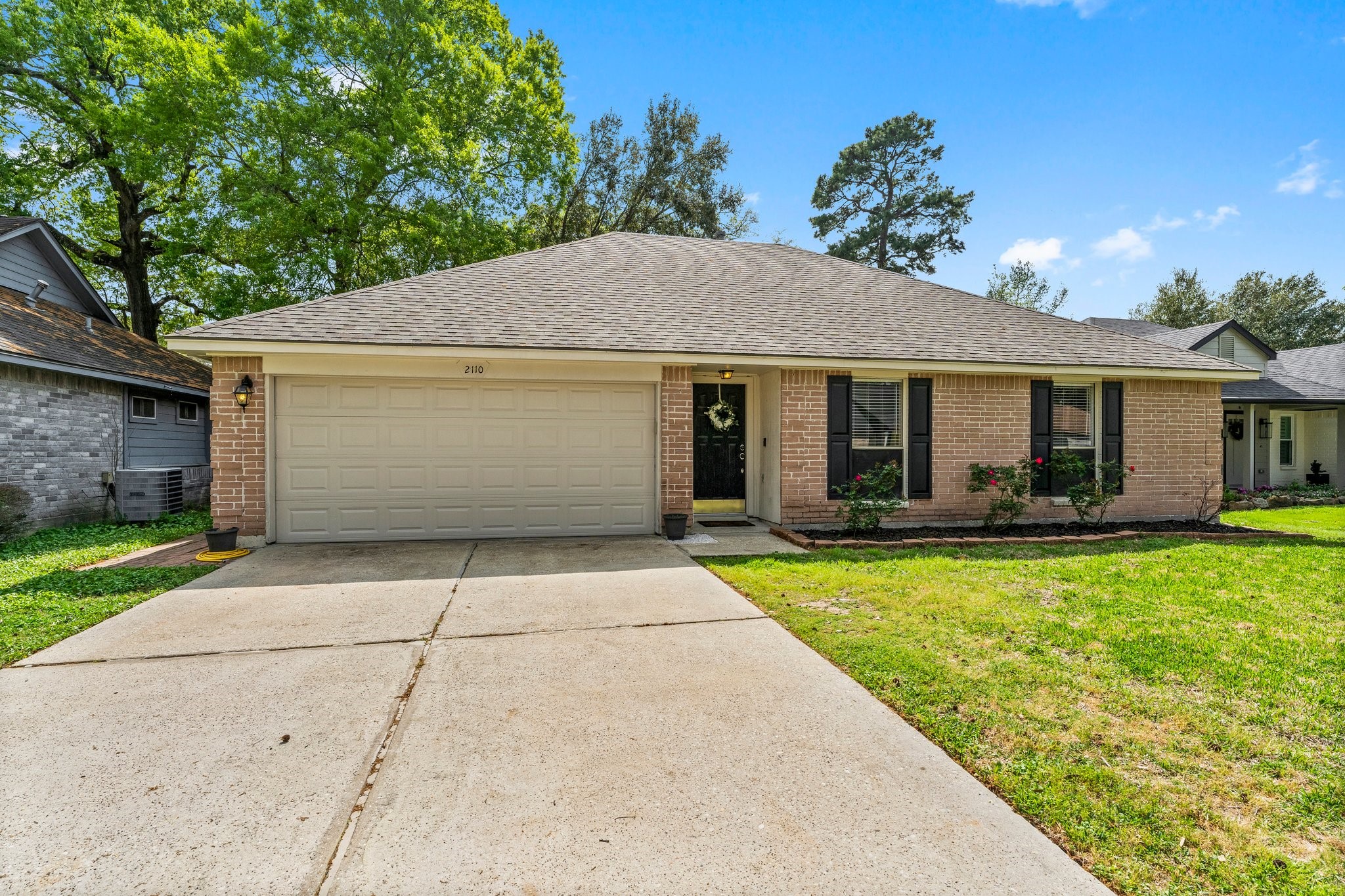 2110 Creston Drive Spring, TX 77386 - Photo 45 of 50 a front view of house with yard and trees in the background