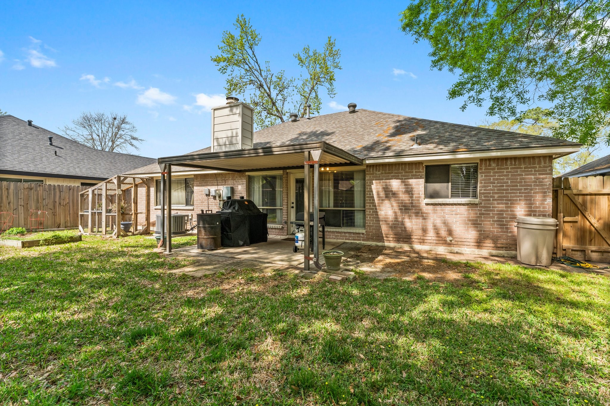 2110 Creston Drive Spring, TX 77386 - Photo 47 of 50 a backyard of a house with yard table and chairs