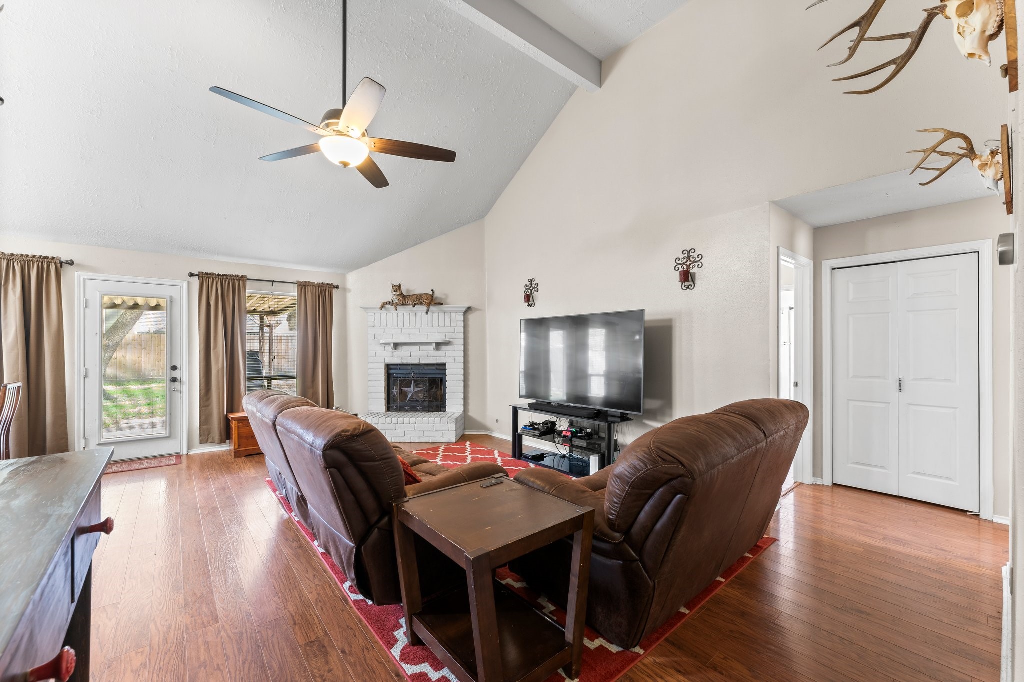 2110 Creston Drive Spring, TX 77386 - Photo 9 of 50 a living room with fireplace furniture and a flat screen tv