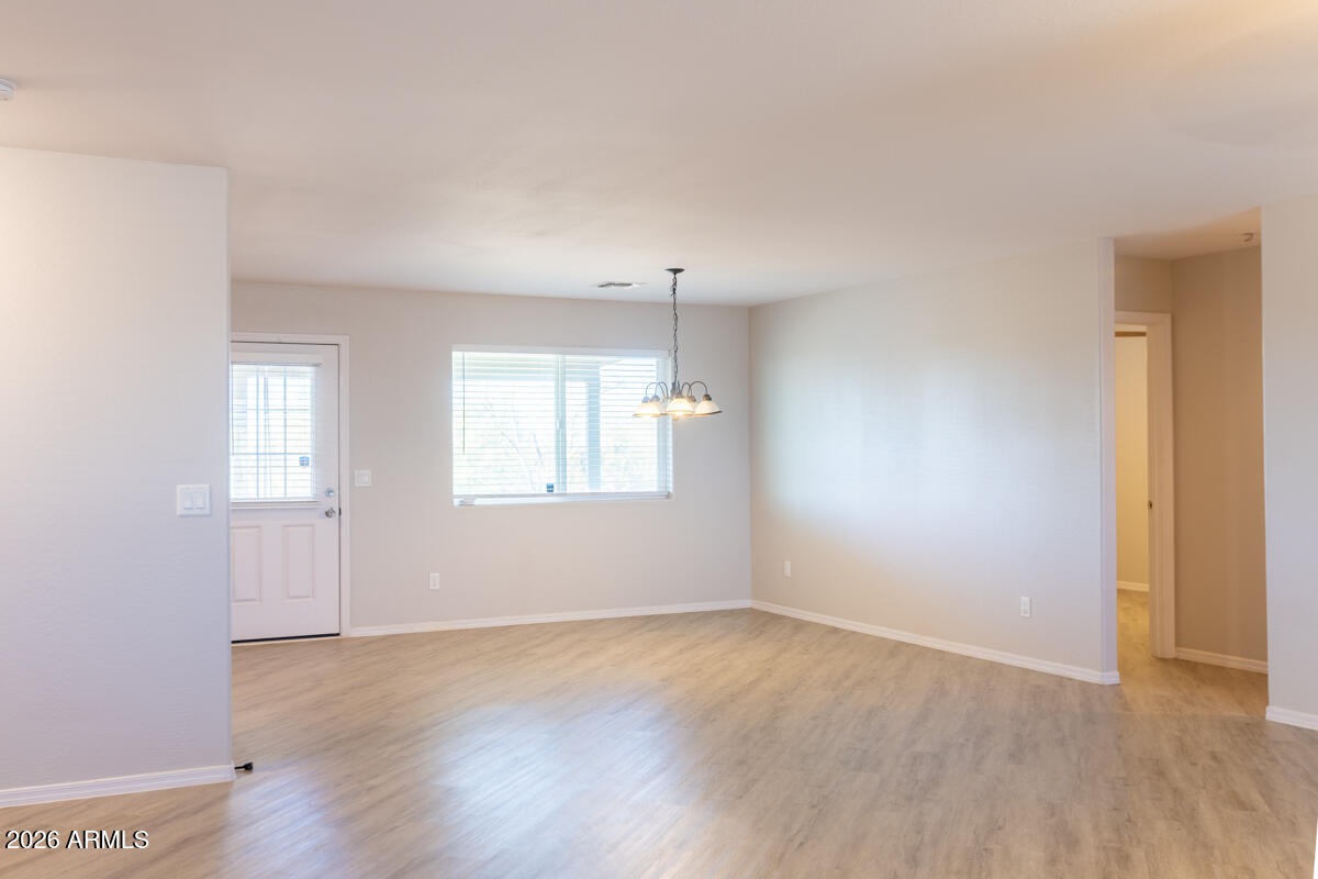 24638 East Bartlett Road Florence, AZ 85132 - Photo 10 of 21 an empty room with wooden floor and windows
