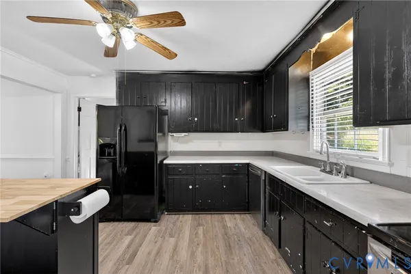 a kitchen with a sink appliances and cabinets