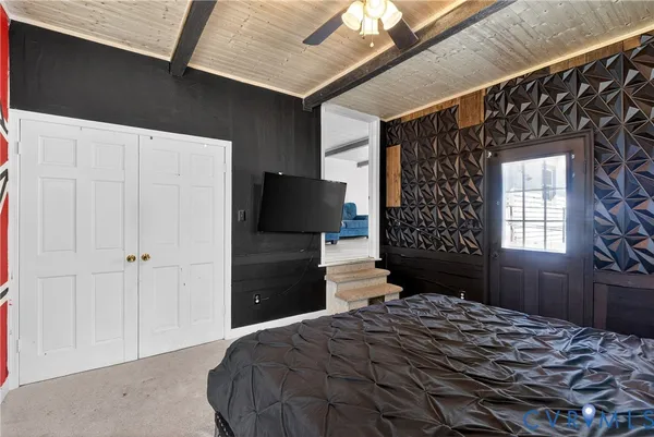 a bedroom with a bed dresser and a window