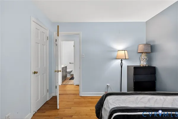a bedroom with a bed and a lamp