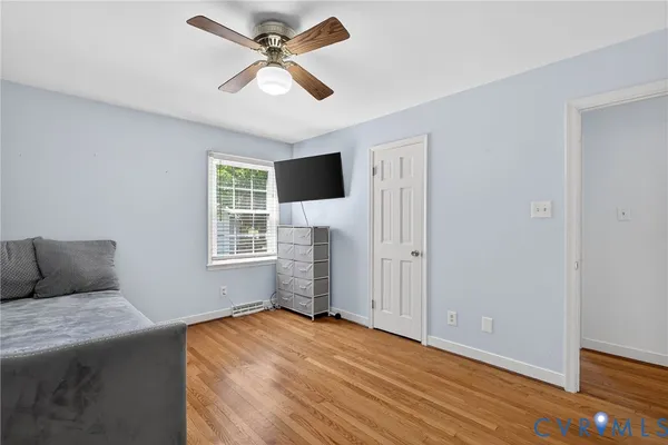 a bedroom with a bed and a ceiling fan