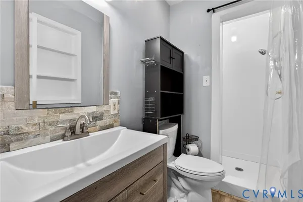 a bathroom with a sink toilet and shower