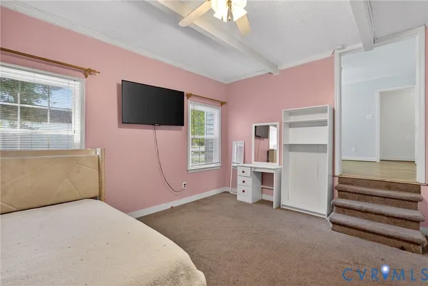 a bedroom with furniture and a flat screen tv