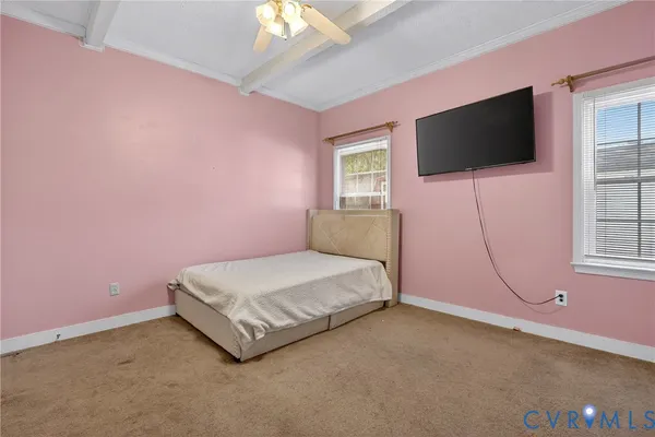 a spacious bedroom with a bed and a flat screen tv