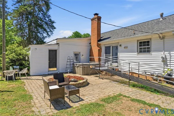 a backyard of a house with table and chairs