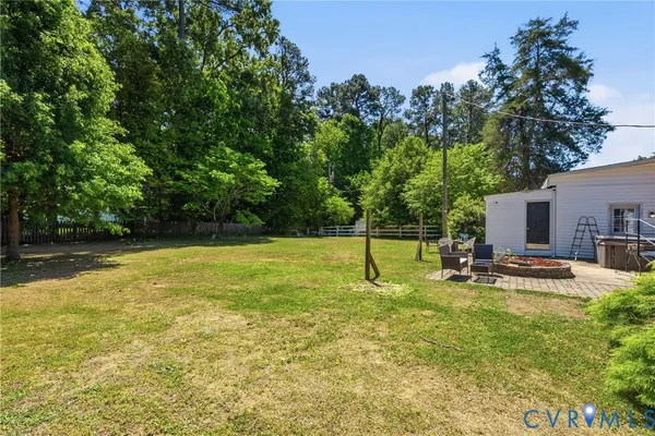 a swimming pool with lots of tress in front of it
