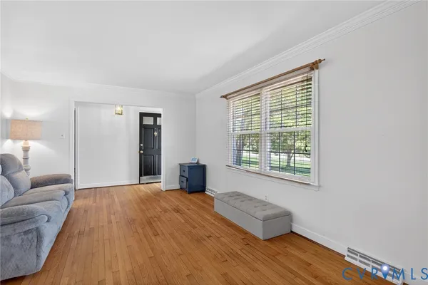 a spacious bedroom with a bed couch and a window