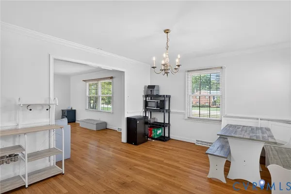 a living room with furniture and window with wooden floor