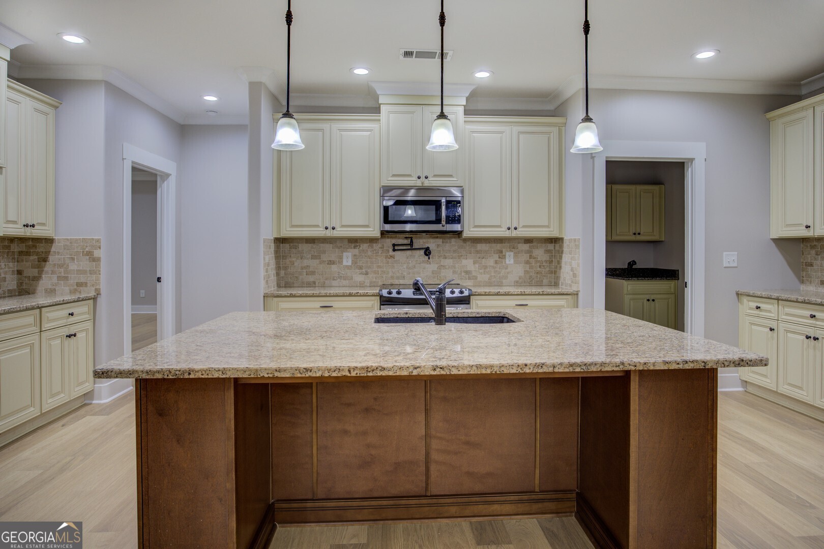 284 Sowell Road McDonough, GA 30252 - Photo 12 of 48 a large kitchen with kitchen island granite countertop a stove a sink a center island and stainless steel appliances
