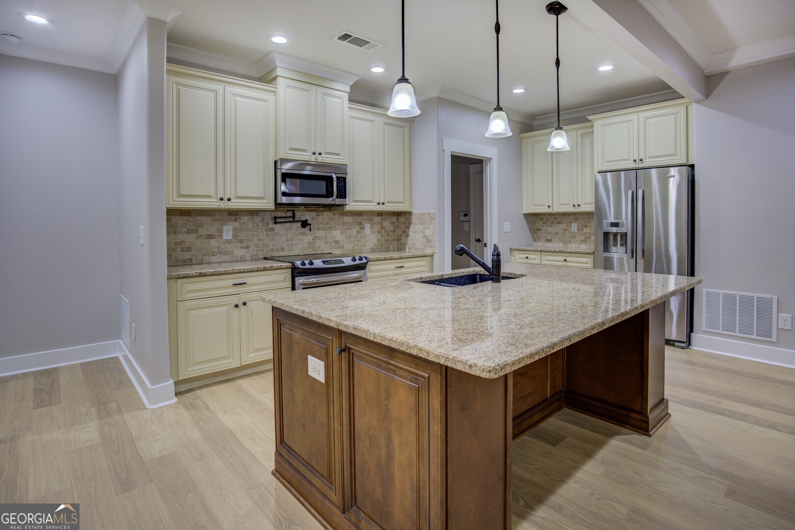 284 Sowell Road McDonough, GA 30252 - Photo 13 of 48 a kitchen with stainless steel appliances granite countertop a kitchen island a stove a refrigerator a sink and a microwave