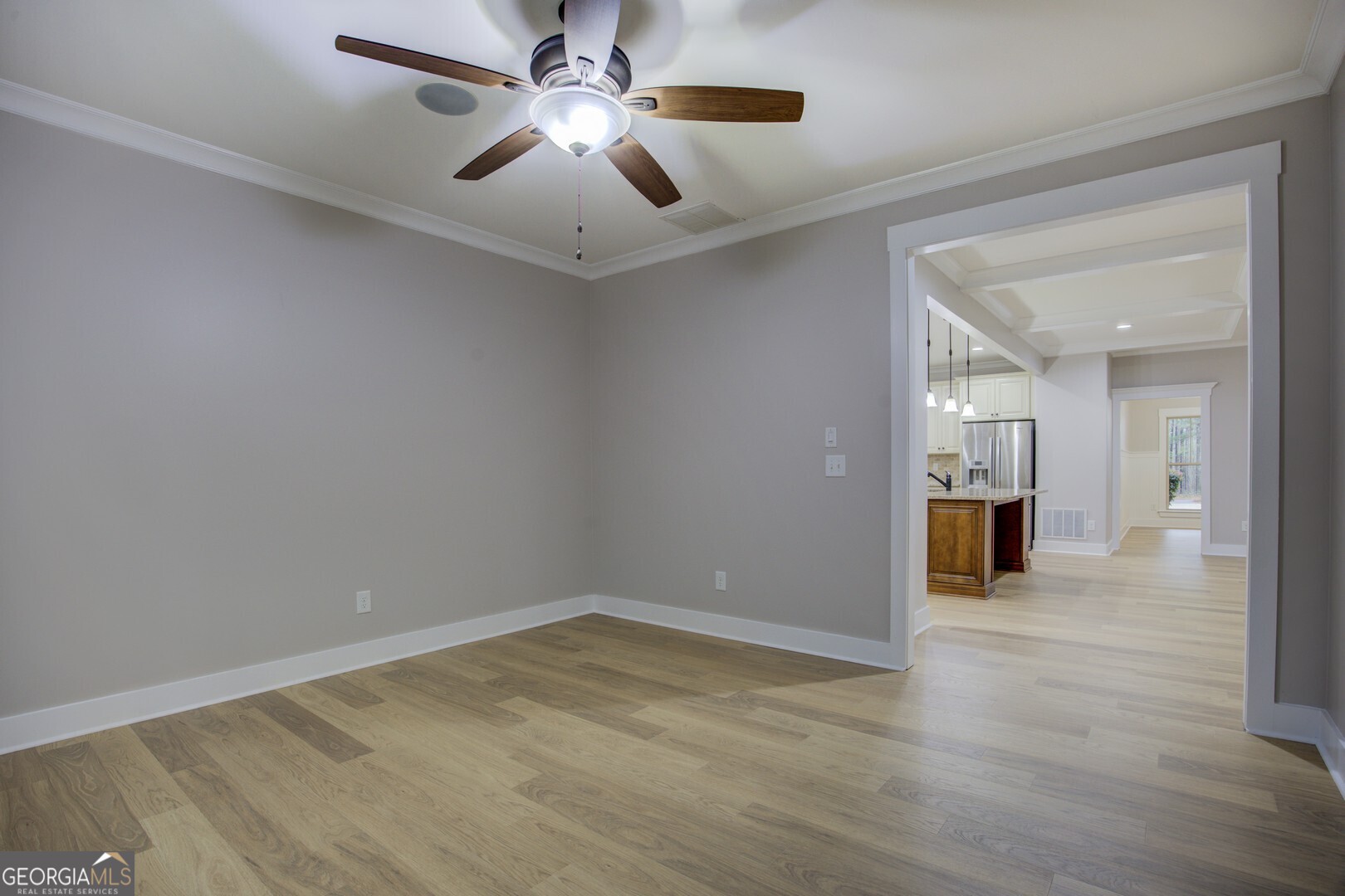 284 Sowell Road McDonough, GA 30252 - Photo 25 of 48 a view of a livingroom with wooden floor and a ceiling fan