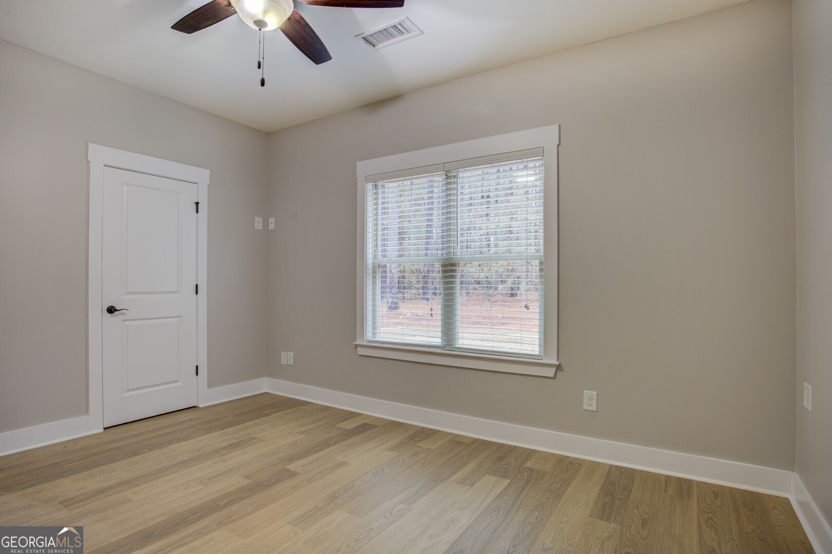 284 Sowell Road McDonough, GA 30252 - Photo 38 of 48 a view of an empty room with wooden floor and a window
