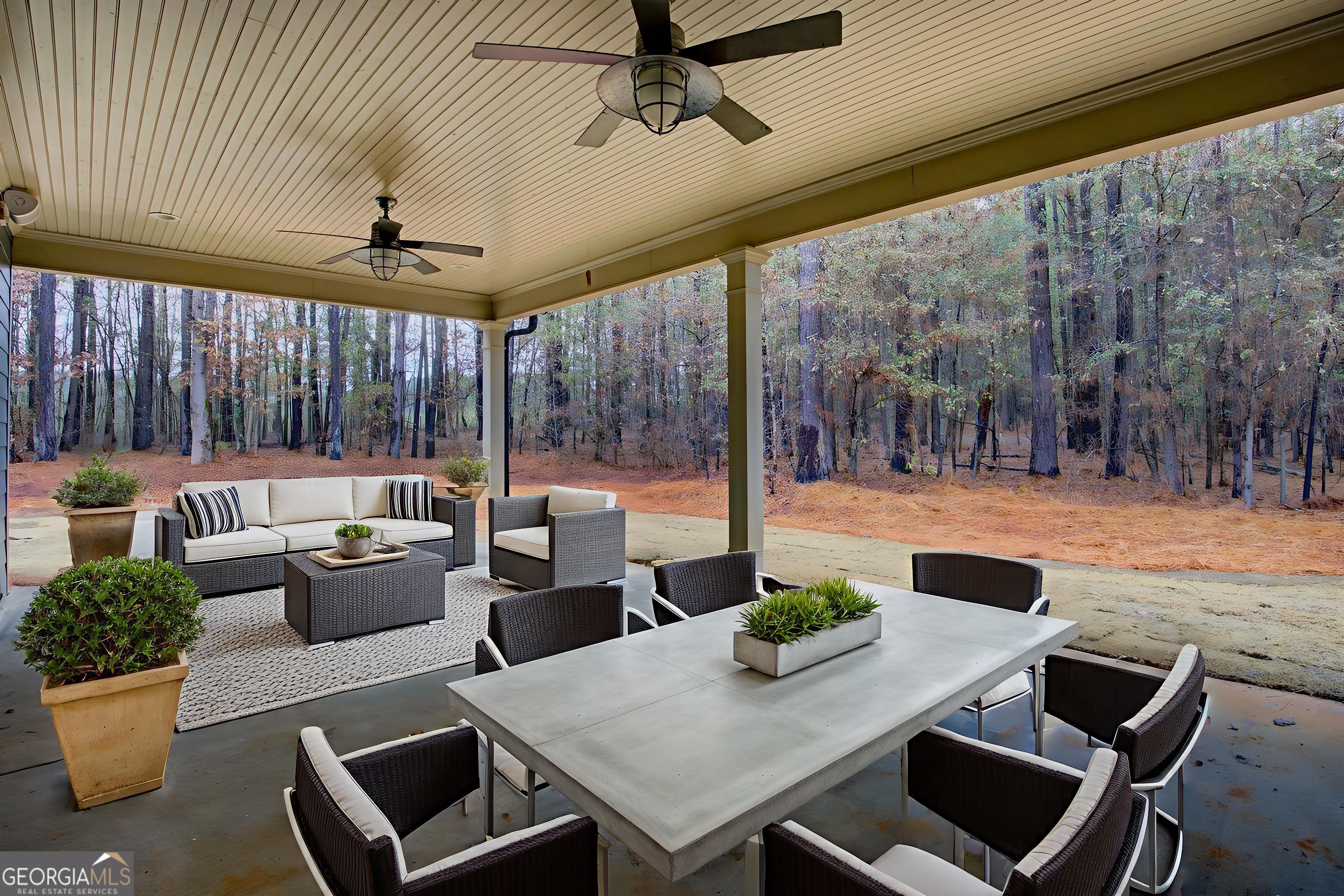 284 Sowell Road McDonough, GA 30252 - Photo 40 of 48 a view of a patio with couches chairs and a potted plant