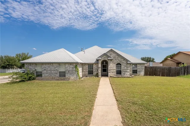 a front view of a house with yard