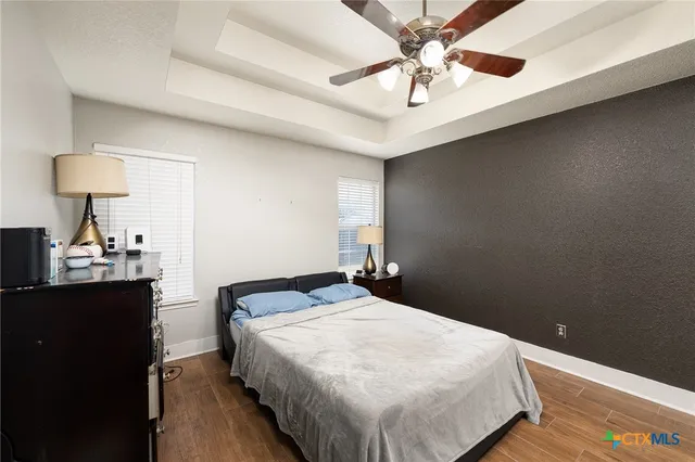 a bedroom with a bed and a lamp on the dresser