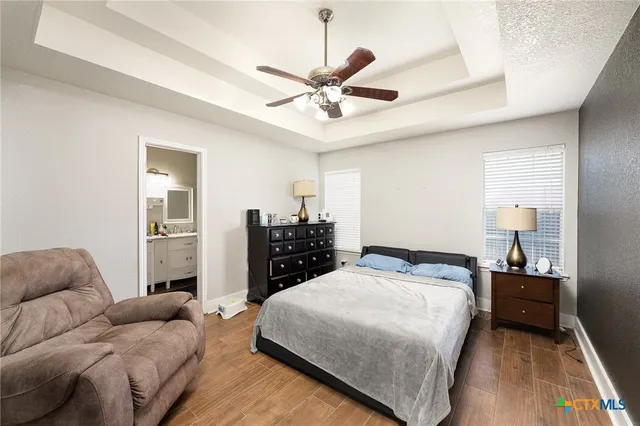 a bedroom with a bed and ceiling fan